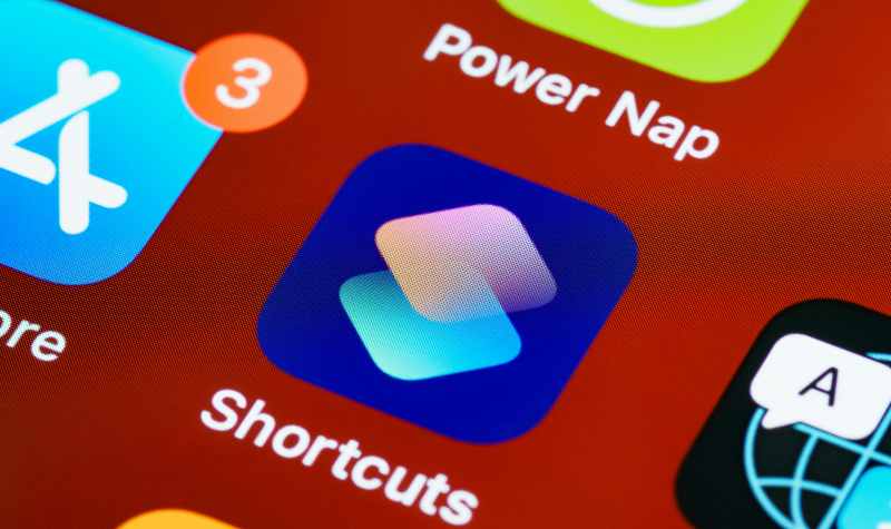 "Smartphone screen showing app icons, including 'Shortcuts' with a badge of three notifications."