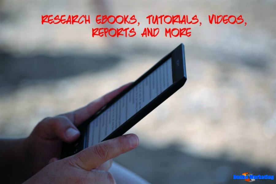 Person reading on an e-reader outdoors.