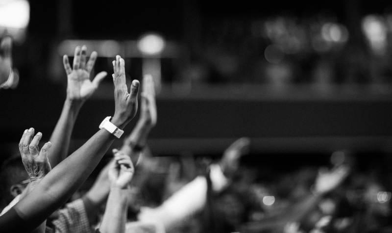 Raised hands of an audience at a concert or event.