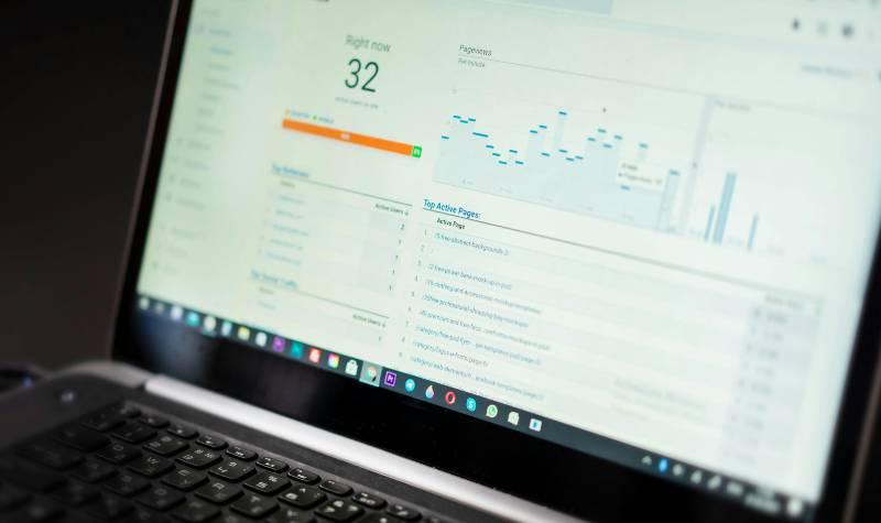 Laptop screen displaying analytics data with graphs and key metrics.