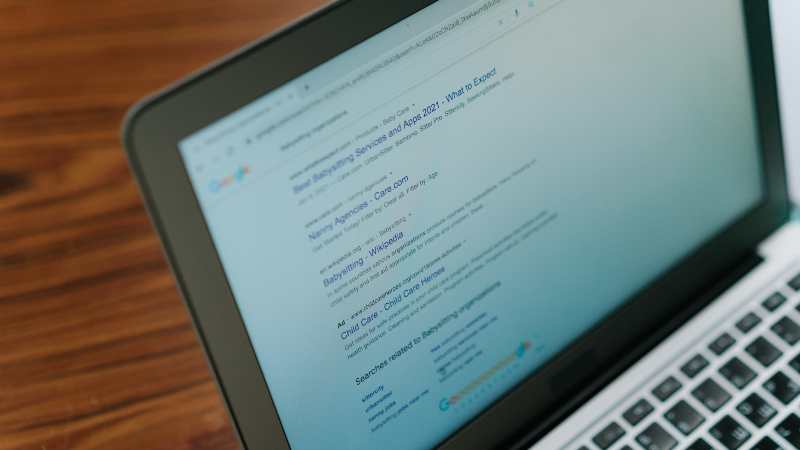 Laptop screen displaying a Google search results page about babysitting services.