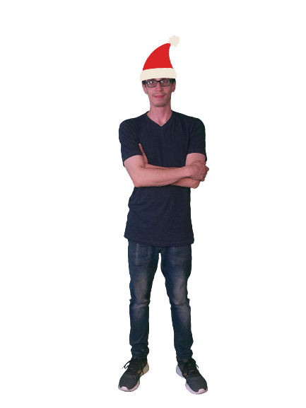 Man with crossed arms wearing casual clothes and a Santa hat against black background.